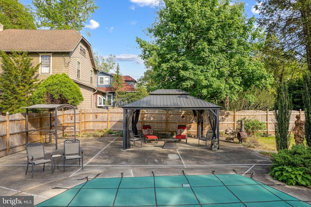 view of patio with a fenced backyard, a fenced in pool, and a gazebo