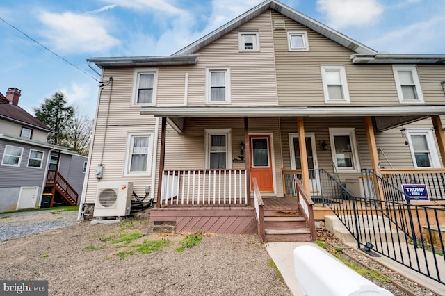 townhome / multi-family property featuring a porch and ac unit