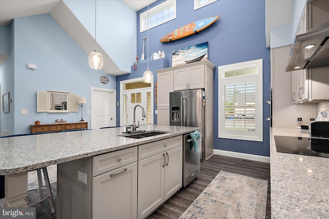 14626 Blue Heron Dr, Ocean View, DE 19970 - kitchen with a high ceiling, a sink, under cabinet range hood, appliances with stainless steel finishes, and dark wood finished floors