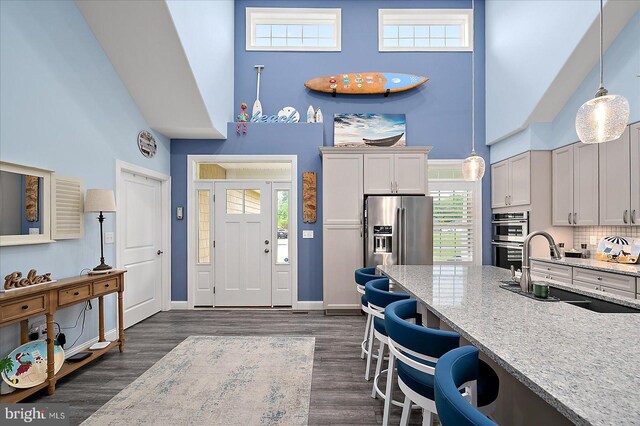 14626 Blue Heron Dr, Ocean View, DE 19970 - entrance foyer featuring a towering ceiling, dark wood-style flooring, and baseboards