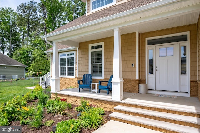 14626 Blue Heron Dr, Ocean View, DE 19970 - entrance to property with covered porch, roof with shingles, and central AC unit