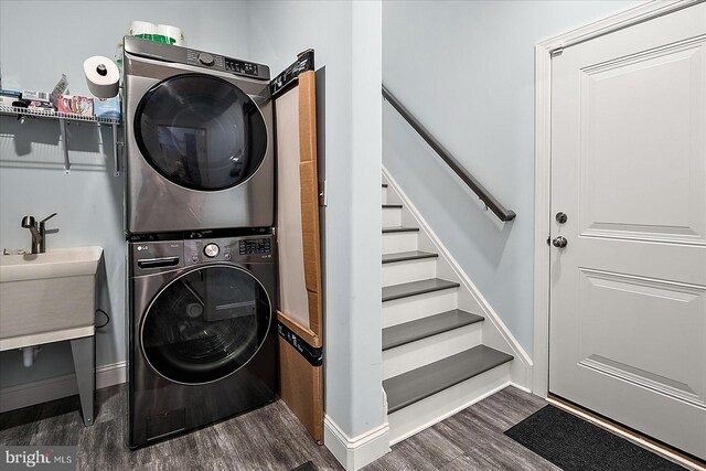 14626 Blue Heron Dr, Ocean View, DE 19970 - laundry area featuring stacked washer and clothes dryer, dark wood-style flooring, and baseboards