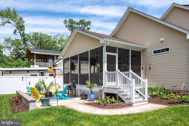 14626 Blue Heron Dr, Ocean View, DE 19970 - rear view of property featuring a sunroom and a patio area