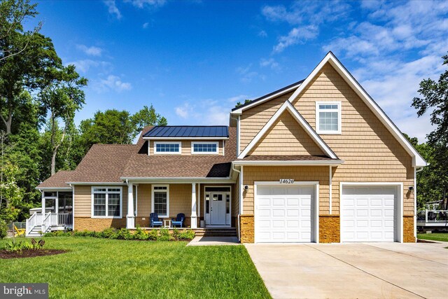 14626 Blue Heron Dr, Ocean View, DE 19970 - view of front of house featuring concrete driveway, covered porch, a front lawn, a garage, and brick siding