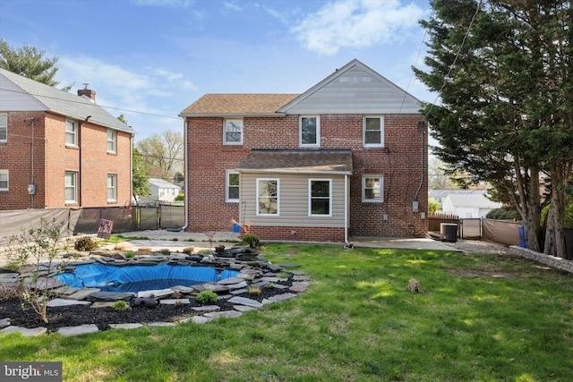 510 W S Ave, Glenolden, PA 19036 - rear view of property featuring a yard, a patio area, a fenced backyard, brick siding, and a fenced in pool