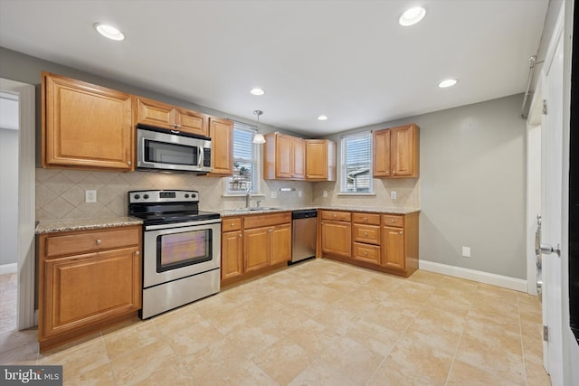 510 W S Ave, Glenolden, PA 19036 - kitchen with appliances with stainless steel finishes, a sink, backsplash, and baseboards