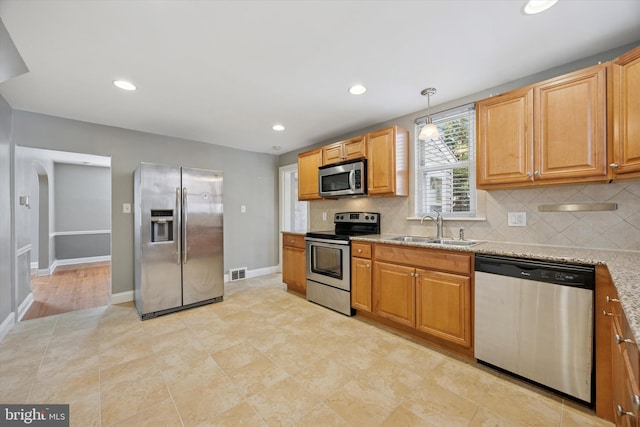 510 W S Ave, Glenolden, PA 19036 - kitchen with visible vents, a sink, stainless steel appliances, backsplash, and light stone counters