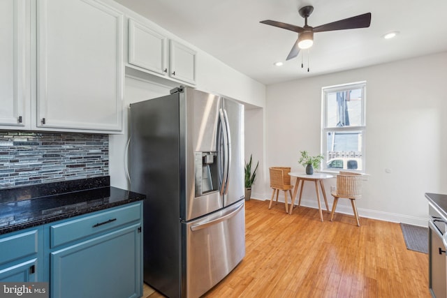 kitchen with a ceiling fan, light wood-type flooring, stainless steel fridge, and tasteful backsplash