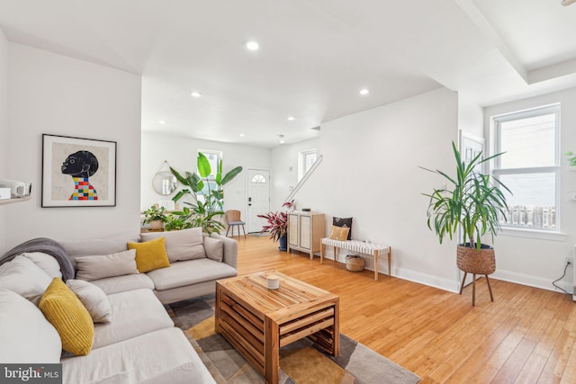 living room with recessed lighting, baseboards, and light wood finished floors