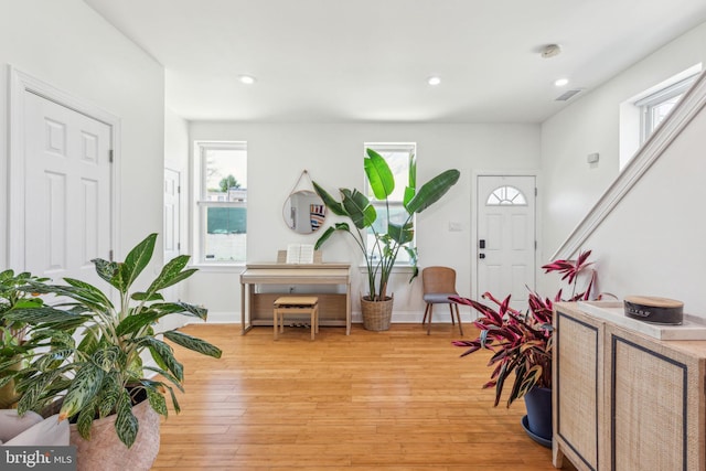foyer entrance featuring recessed lighting, baseboards, light wood finished floors, and visible vents