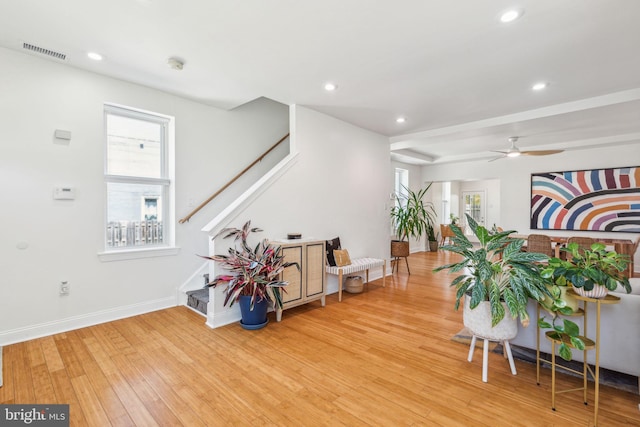 interior space with visible vents, plenty of natural light, wood finished floors, and stairway