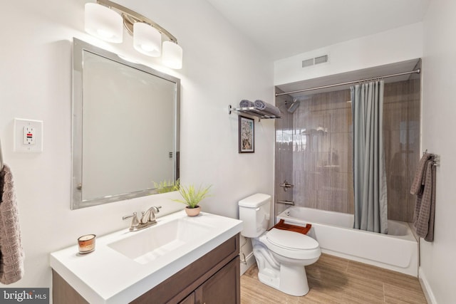 bathroom featuring vanity, toilet, shower / bathtub combination with curtain, wood finished floors, and visible vents