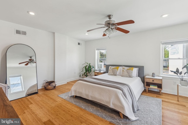 bedroom featuring multiple windows, wood finished floors, and visible vents