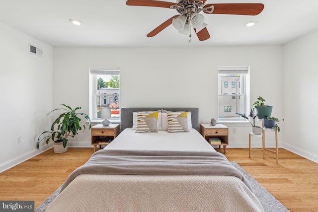 bedroom with recessed lighting, wood finished floors, and visible vents