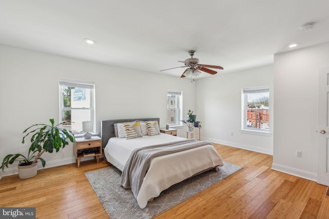 bedroom featuring light wood-type flooring, recessed lighting, and baseboards