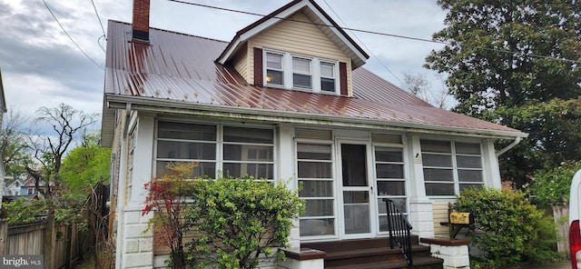209 N Pine St, Seaford, DE 19973 - view of front facade with a chimney, metal roof, and entry steps