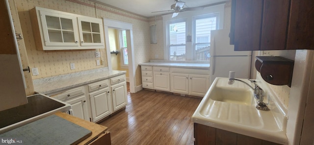 209 N Pine St, Seaford, DE 19973 - kitchen with wallpapered walls, white appliances, dark wood finished floors, a ceiling fan, and light countertops