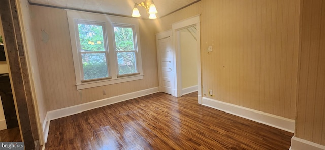 209 N Pine St, Seaford, DE 19973 - unfurnished bedroom featuring wood finished floors, baseboards, and a chandelier