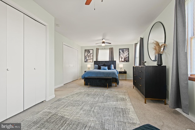 carpeted bedroom featuring ceiling fan and multiple windows