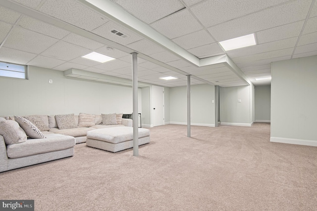carpeted living area with visible vents, baseboards, and a paneled ceiling