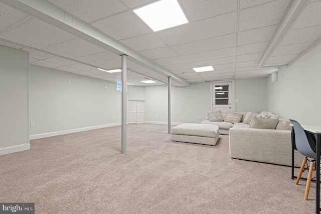 carpeted living room featuring a paneled ceiling