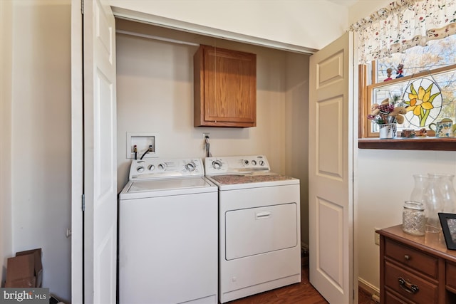 washroom featuring washing machine and clothes dryer, dark wood-style flooring, and cabinet space