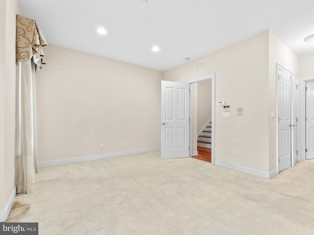 unfurnished bedroom with recessed lighting, carpet floors, visible vents, and baseboards
