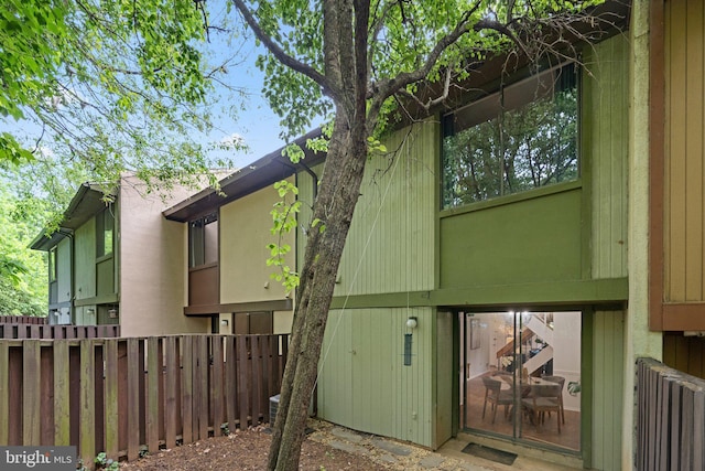 view of home's exterior with fence