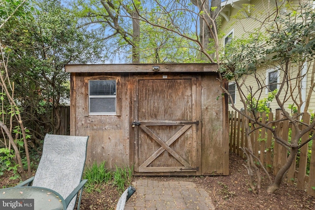 view of shed with fence