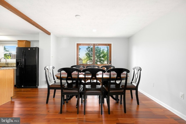 dining space with a healthy amount of sunlight, baseboards, and dark wood-style floors