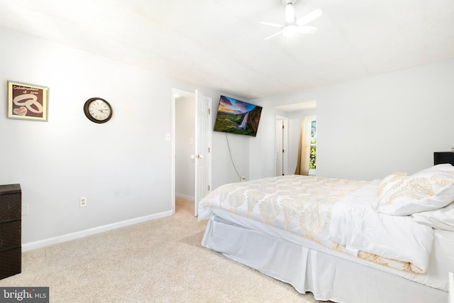bedroom with a ceiling fan, baseboards, and carpet