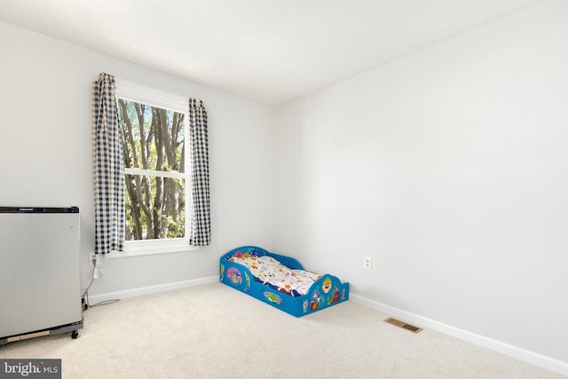 unfurnished bedroom with baseboards, carpet flooring, and visible vents
