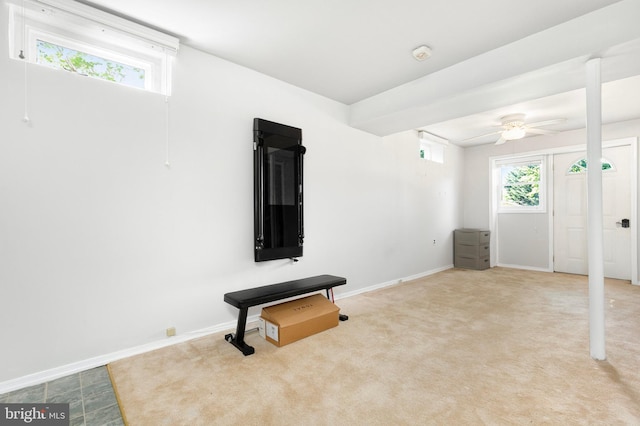 interior space with baseboards, carpet, and ceiling fan