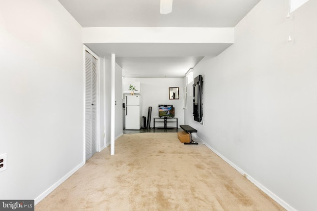 corridor with carpet floors and baseboards