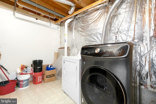 washroom with separate washer and dryer, laundry area, and tile patterned floors