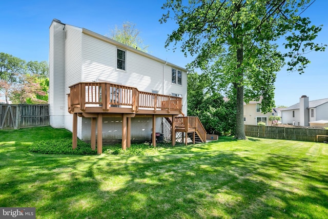 back of house featuring a fenced backyard, a lawn, a wooden deck, and stairs