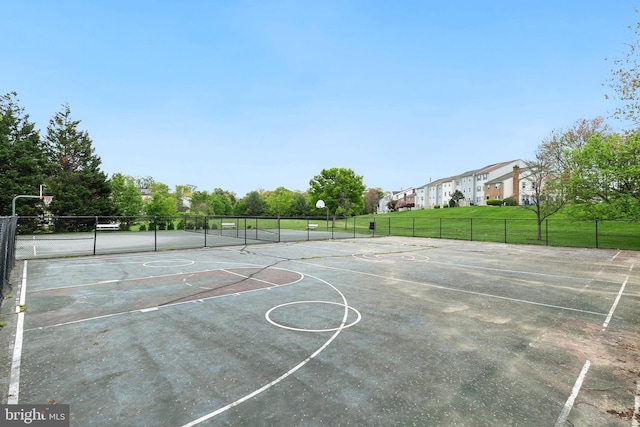 view of basketball court featuring community basketball court and fence