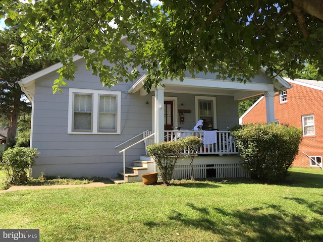 bungalow with a porch and a front yard