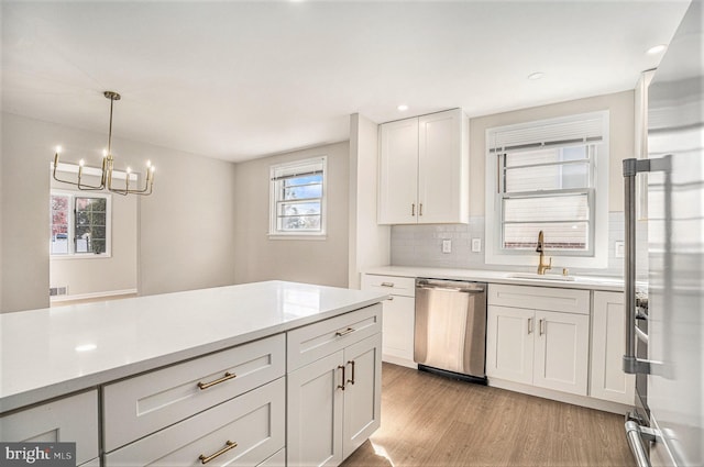 3839 Chalfont Dr, Philadelphia, PA 19154 - kitchen with light wood-style floors, stainless steel appliances, light countertops, and a sink