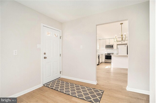 3839 Chalfont Dr, Philadelphia, PA 19154 - foyer entrance featuring a chandelier, light wood finished floors, and baseboards