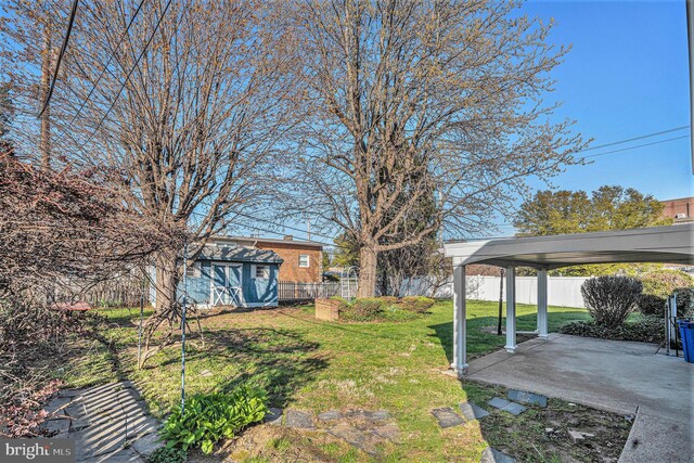 3839 Chalfont Dr, Philadelphia, PA 19154 - view of yard featuring a fenced backyard, a storage unit, an outbuilding, and a patio