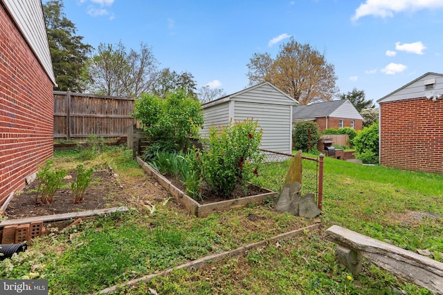 view of yard with an outbuilding, a garden, and fence