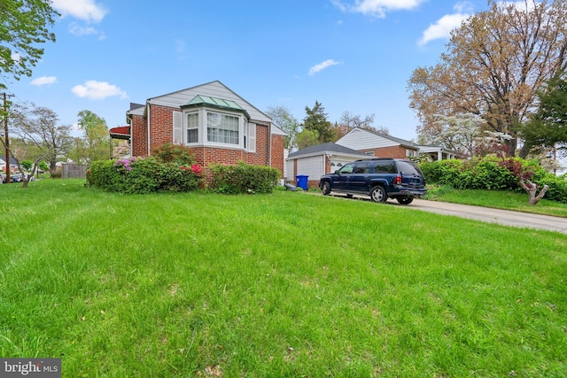 view of front of house with a front yard and brick siding