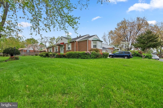 view of home's exterior featuring brick siding and a lawn