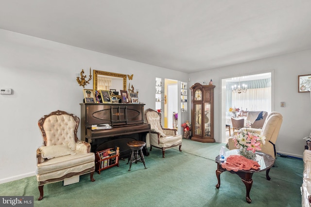 sitting room with a notable chandelier and carpet floors