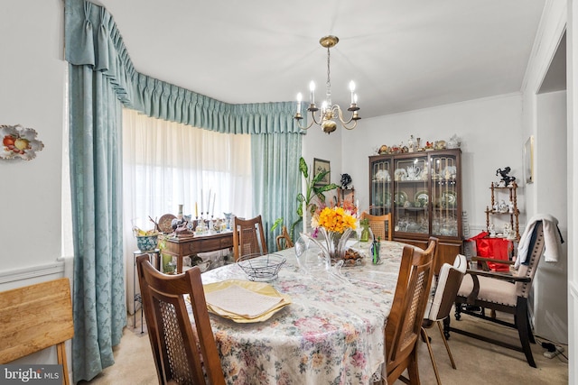 dining area featuring a notable chandelier and light carpet
