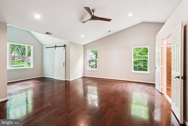 5856 Kittewan Ct, Manassas, VA 20112 - unfurnished bedroom with a barn door, lofted ceiling, multiple windows, dark wood-style floors, and recessed lighting