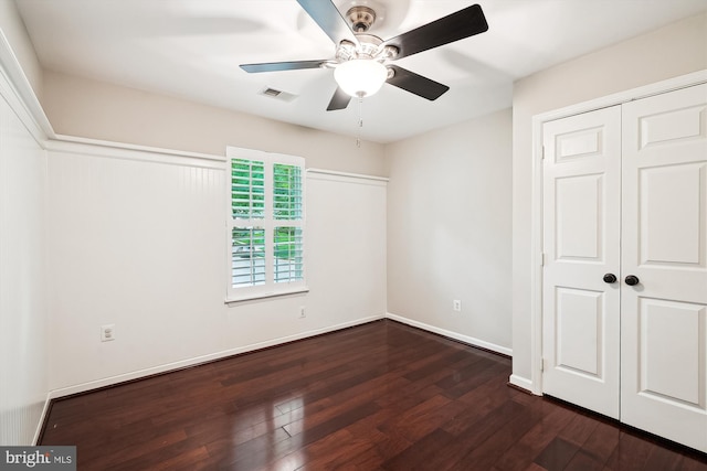 5856 Kittewan Ct, Manassas, VA 20112 - unfurnished bedroom with dark wood-style flooring, a closet, a ceiling fan, and baseboards