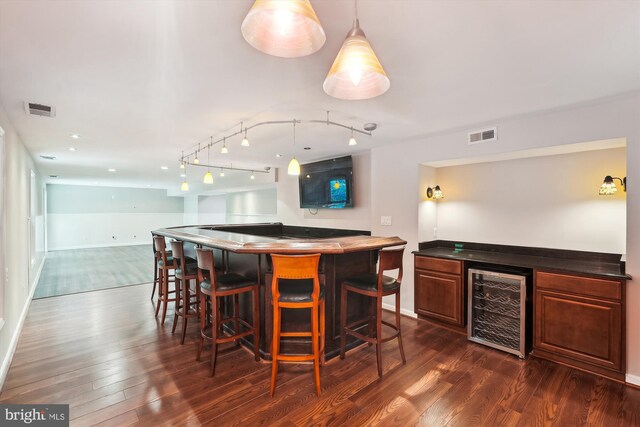 5856 Kittewan Ct, Manassas, VA 20112 - indoor dry bar with wine cooler, dark wood finished floors, baseboards, and track lighting