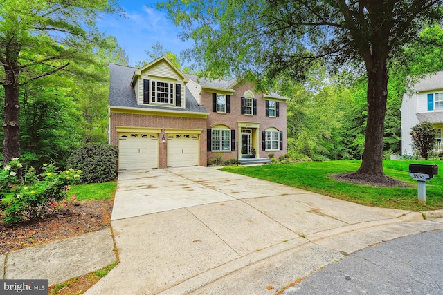 5856 Kittewan Ct, Manassas, VA 20112 - view of front facade featuring driveway, an attached garage, brick siding, and a front yard